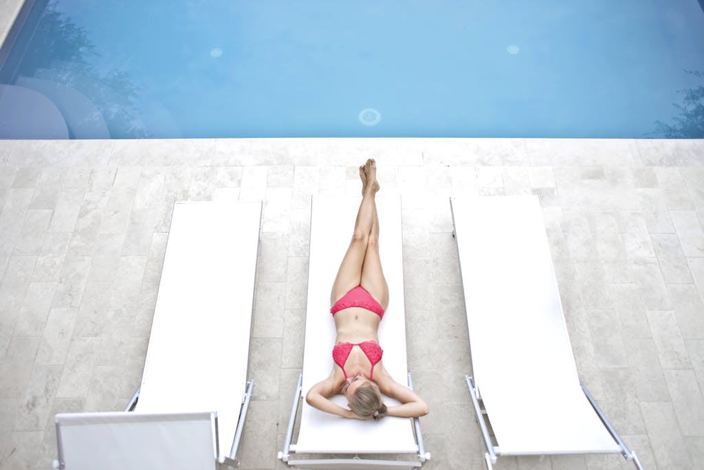 Woman Lying on White Sun Lounger